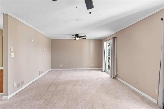 empty room featuring baseboards, visible vents, a ceiling fan, and light colored carpet