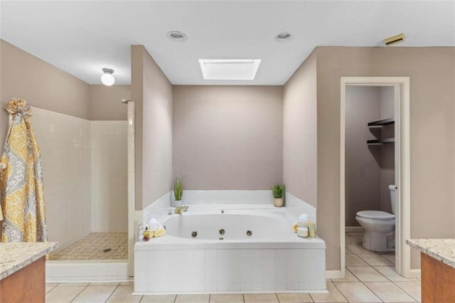 bathroom with toilet, vanity, tiled shower, a jetted tub, and tile patterned floors