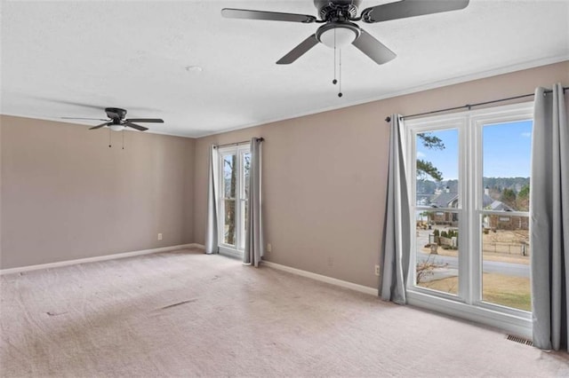 unfurnished room featuring carpet flooring, a ceiling fan, and baseboards