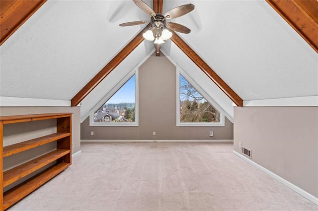 bonus room featuring baseboards, visible vents, vaulted ceiling, and carpet flooring