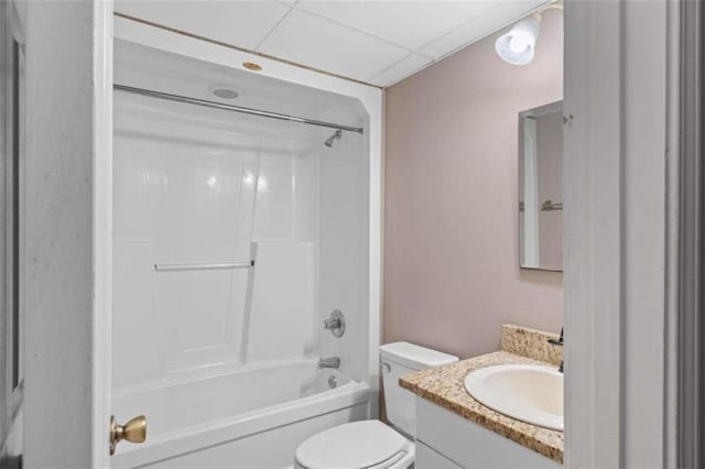 bathroom featuring toilet, shower / washtub combination, a paneled ceiling, and vanity