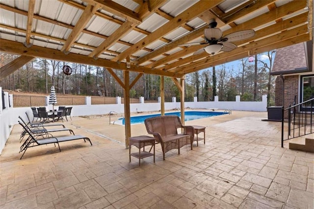 view of patio featuring a fenced in pool, a fenced backyard, and a ceiling fan