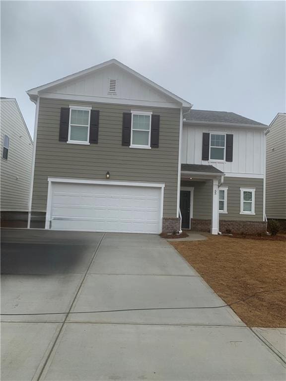 55 Knightsbridge Ln, Winder, GA 30680 - view of front of property featuring board and batten siding, an attached garage, concrete driveway, and brick siding