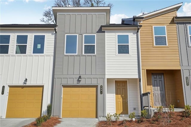 multi unit property featuring driveway, board and batten siding, and an attached garage