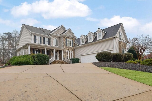 view of front of home featuring a porch and a garage