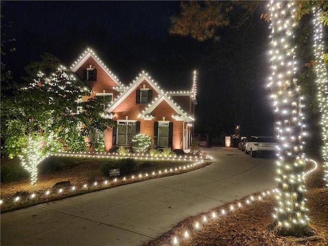 view of front of property featuring brick siding and driveway