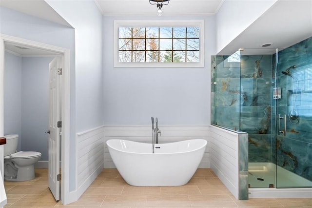 bathroom with ornamental molding, plus walk in shower, and toilet