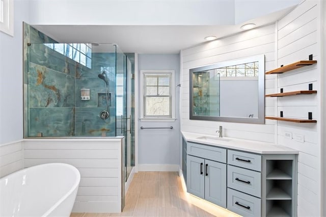 bathroom featuring vanity and independent shower and bath