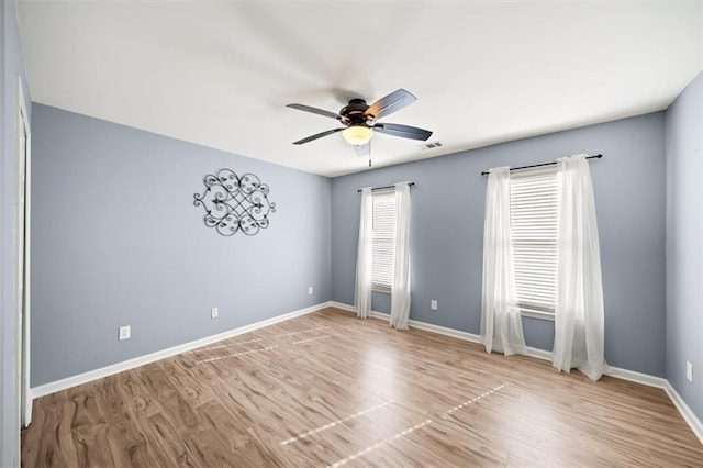 spare room featuring ceiling fan and light wood-type flooring