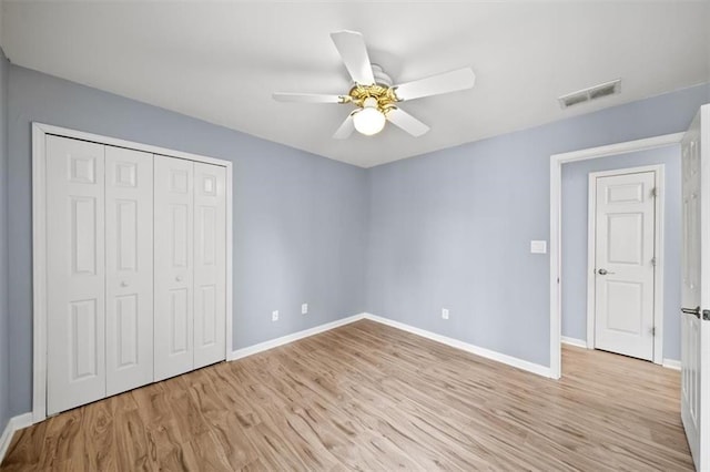 unfurnished bedroom with ceiling fan, light hardwood / wood-style floors, and a closet