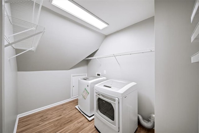 washroom with independent washer and dryer and hardwood / wood-style floors