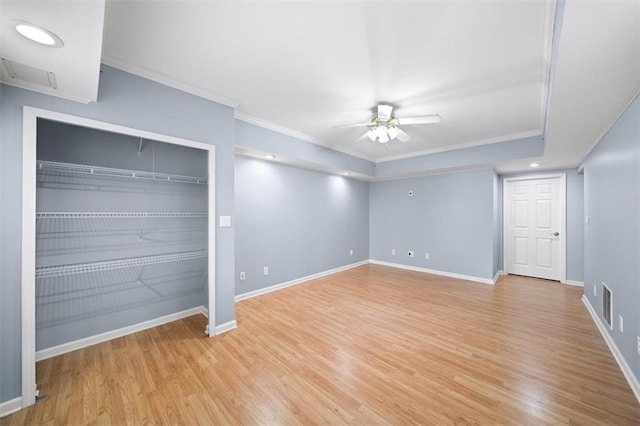 unfurnished bedroom featuring ceiling fan, ornamental molding, and light hardwood / wood-style floors