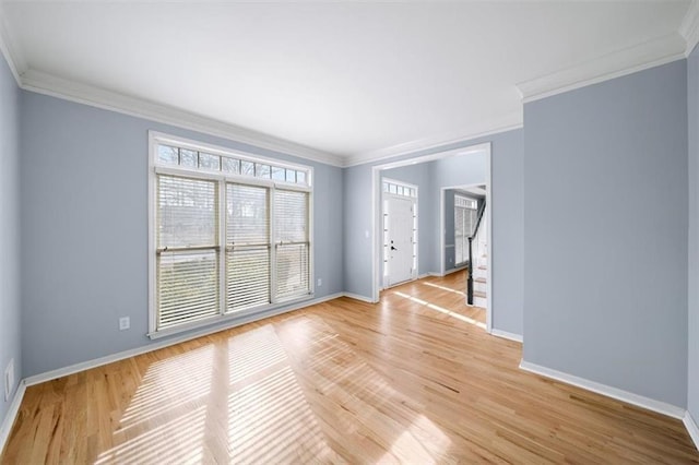 unfurnished room with crown molding and light wood-type flooring