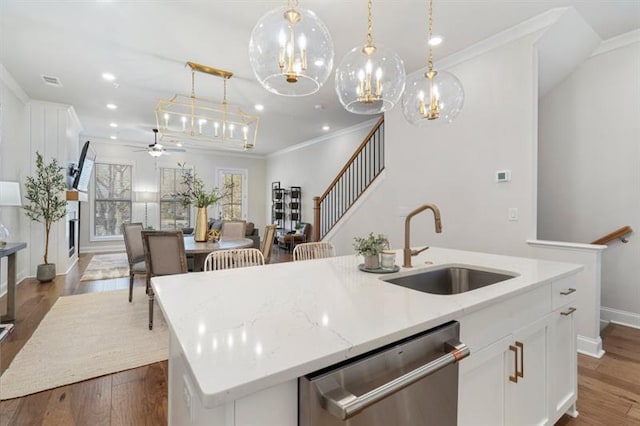124 Everley Walk, Alpharetta, GA 30009 - kitchen featuring stainless steel dishwasher, a sink, crown molding, a center island with sink, and baseboards