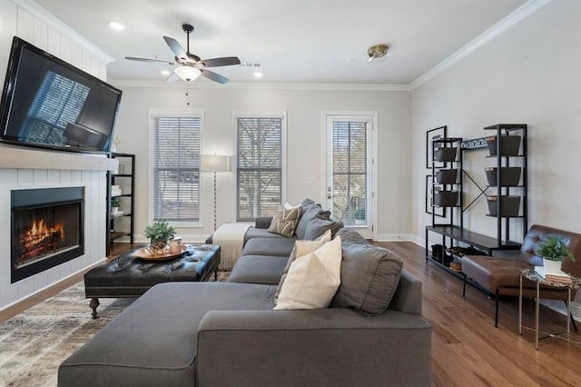124 Everley Walk, Alpharetta, GA 30009 - living area featuring crown molding, wood finished floors, ceiling fan, a fireplace, and baseboards