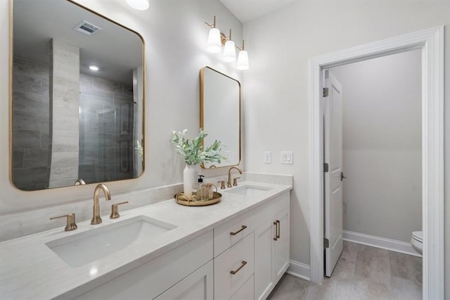 124 Everley Walk, Alpharetta, GA 30009 - bathroom with double vanity, toilet, and baseboards