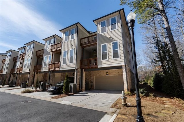 124 Everley Walk, Alpharetta, GA 30009 - view of front facade with a garage, concrete driveway, a residential view, and brick siding
