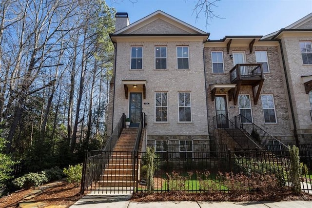 124 Everley Walk, Alpharetta, GA 30009 - view of property featuring stairway, a fenced front yard, a chimney, and brick siding