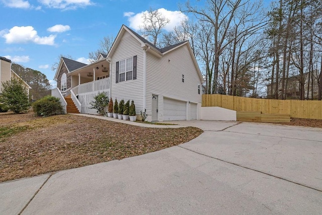 view of property exterior featuring a garage and a porch