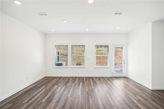 348 White Tail Rd, Stockbridge, GA 30253 - spare room with dark wood-type flooring, baseboards, visible vents, and recessed lighting