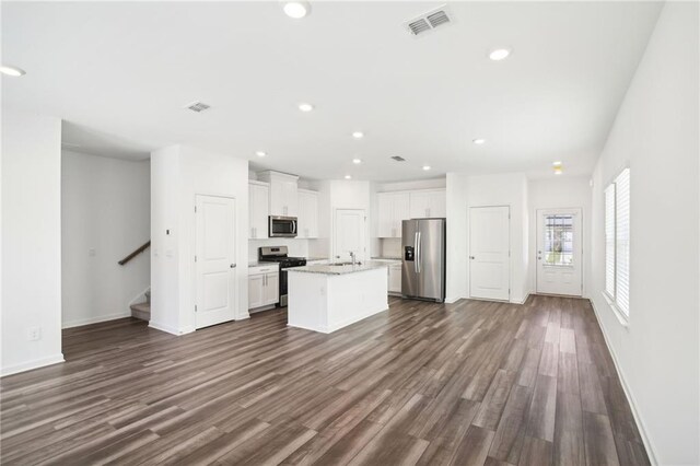 348 White Tail Rd, Stockbridge, GA 30253 - kitchen featuring dark wood-style flooring, white cabinets, visible vents, and appliances with stainless steel finishes