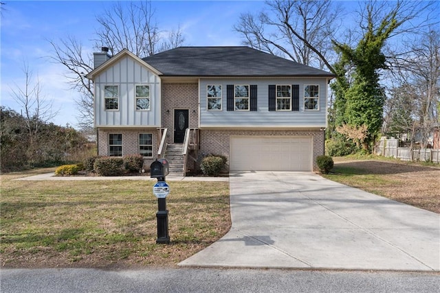 raised ranch featuring driveway, brick siding, a front lawn, and board and batten siding