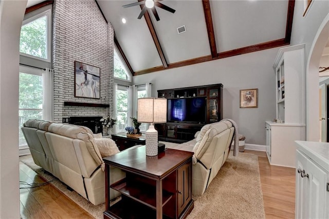 1595 Northcliff Trce, Roswell, GA 30076 - living room featuring high vaulted ceiling, a ceiling fan, a brick fireplace, light wood-style floors, and healthy amount of natural light