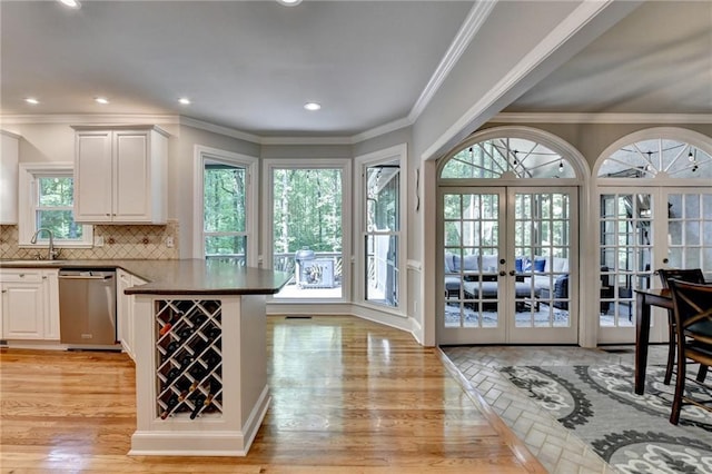 1595 Northcliff Trce, Roswell, GA 30076 - kitchen featuring dishwasher, french doors, white cabinets, a peninsula, and tasteful backsplash