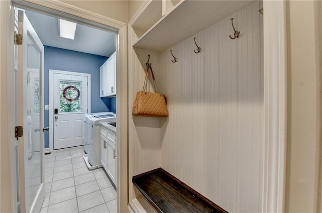 1595 Northcliff Trce, Roswell, GA 30076 - washroom featuring cabinet space, washing machine and clothes dryer, light tile patterned floors, and a skylight