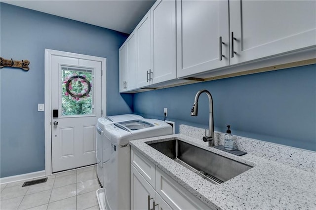 1595 Northcliff Trce, Roswell, GA 30076 - washroom featuring cabinet space, independent washer and dryer, light tile patterned floors, and baseboards