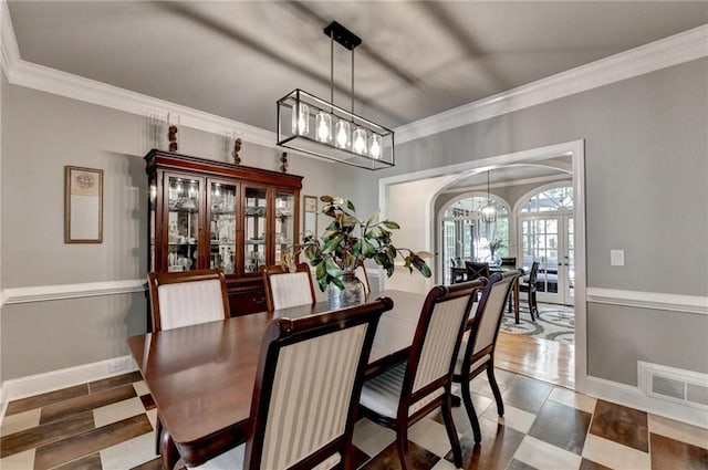 1595 Northcliff Trce, Roswell, GA 30076 - dining room featuring a chandelier, arched walkways, ornamental molding, baseboards, and french doors