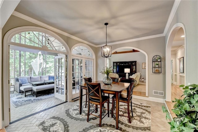 1595 Northcliff Trce, Roswell, GA 30076 - dining space with arched walkways, crown molding, a chandelier, and baseboards