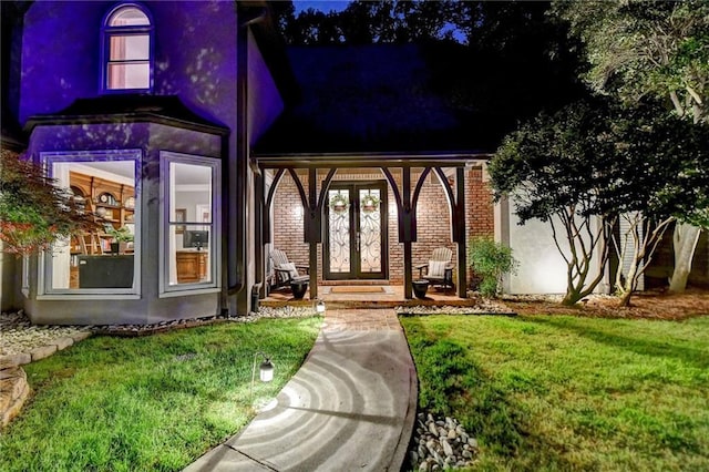 1595 Northcliff Trce, Roswell, GA 30076 - property entrance featuring a lawn, brick siding, french doors, and stucco siding