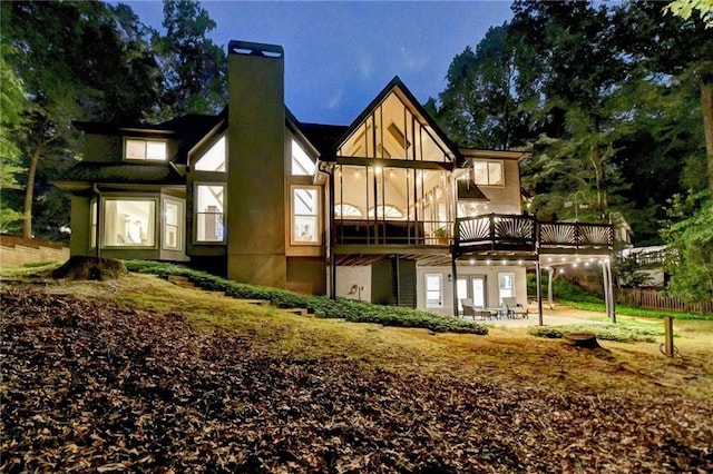 1595 Northcliff Trce, Roswell, GA 30076 - rear view of house featuring a chimney, a wooden deck, a patio area, and stucco siding