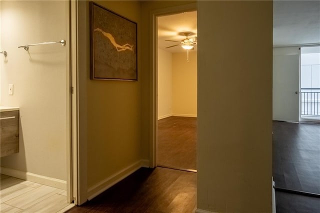 corridor with wood-type flooring