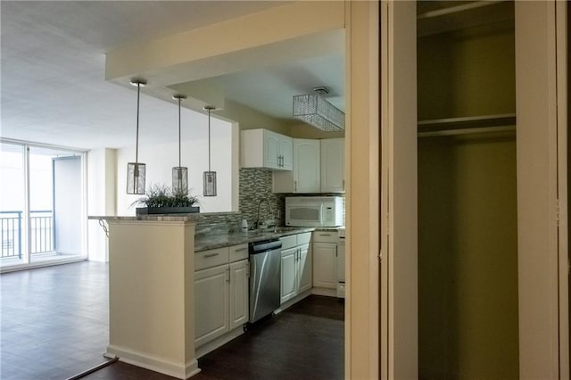 kitchen featuring dishwasher, kitchen peninsula, white cabinets, pendant lighting, and backsplash