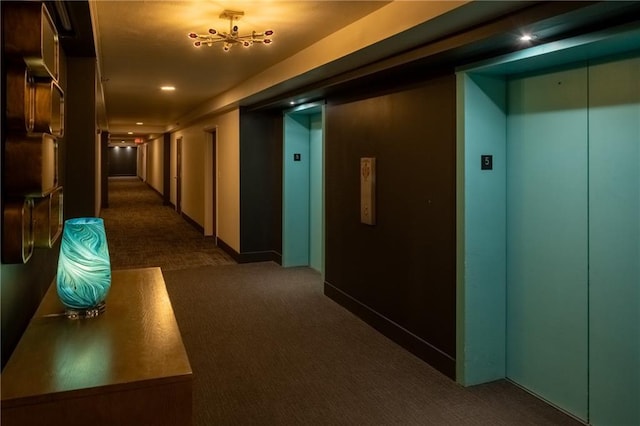 corridor featuring dark colored carpet and elevator