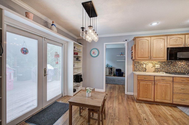 20 Friendship Rd, Euharlee, GA 30145 - kitchen with black microwave, light countertops, stainless steel gas stovetop, backsplash, and light wood finished floors