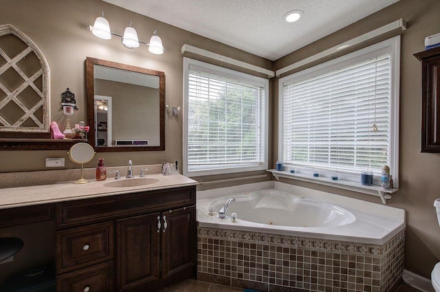 20 Friendship Rd, Euharlee, GA 30145 - bathroom featuring a tub with jets, vanity, and a textured ceiling