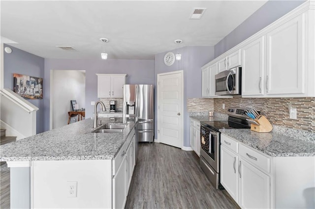 kitchen with a kitchen island with sink, sink, white cabinetry, and stainless steel appliances