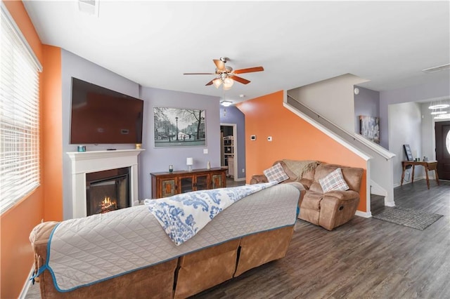 living room featuring dark hardwood / wood-style flooring and ceiling fan