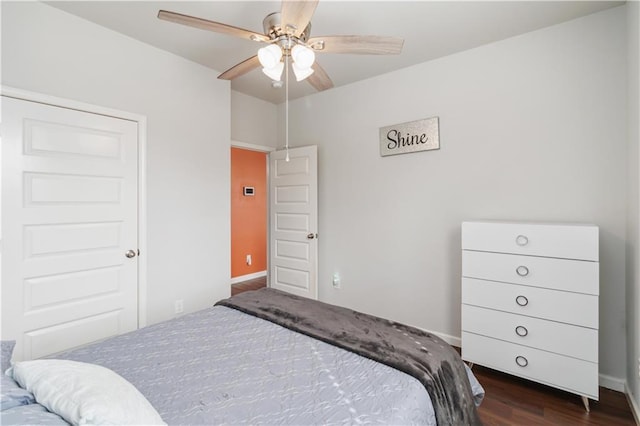 bedroom with ceiling fan and dark hardwood / wood-style floors