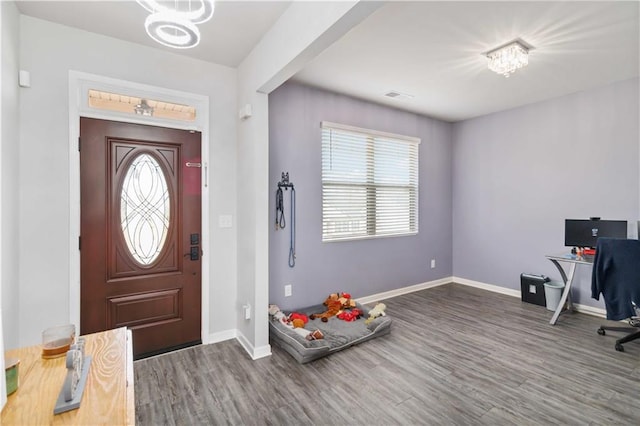 entrance foyer featuring hardwood / wood-style floors and a notable chandelier