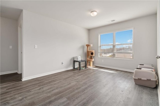 unfurnished room with dark hardwood / wood-style floors