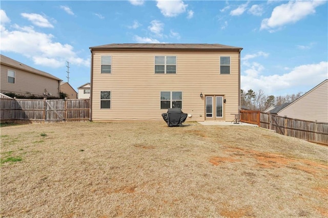 back of house featuring a patio and a lawn