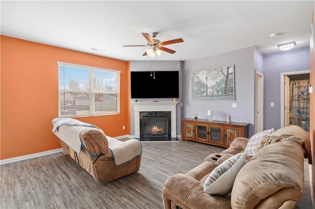 living room with wood-type flooring and ceiling fan