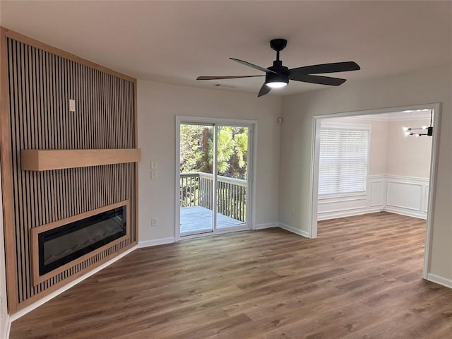 unfurnished living room featuring wood-type flooring and ceiling fan