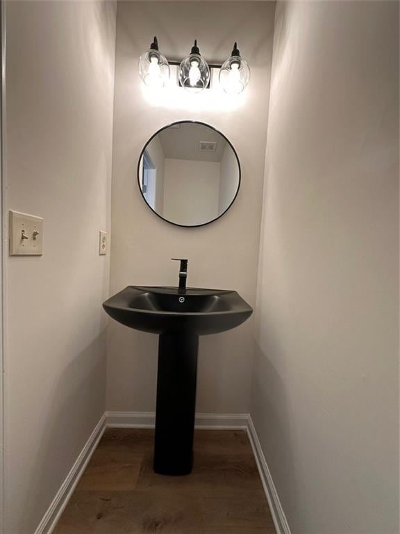 bathroom featuring sink and hardwood / wood-style floors