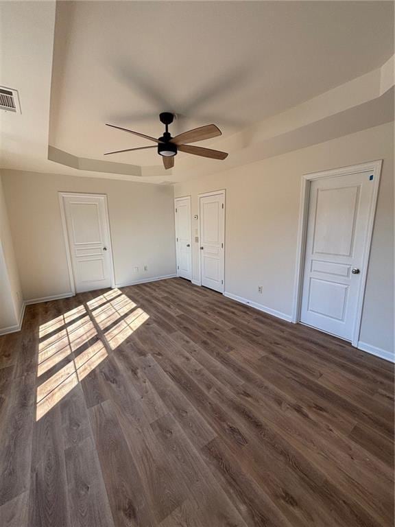 unfurnished bedroom featuring dark hardwood / wood-style flooring and ceiling fan