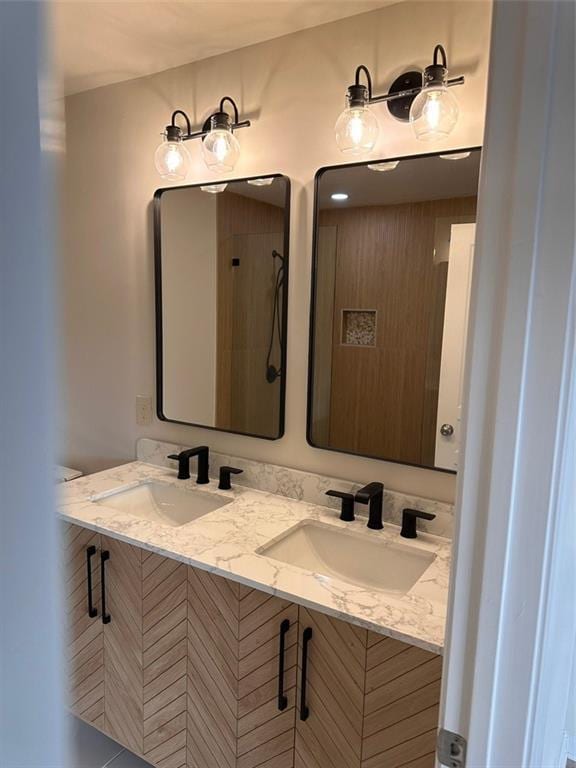 bathroom with vanity and a shower